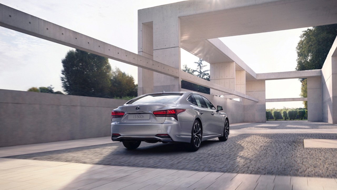 Lexus LS 500h parked under an abstract building